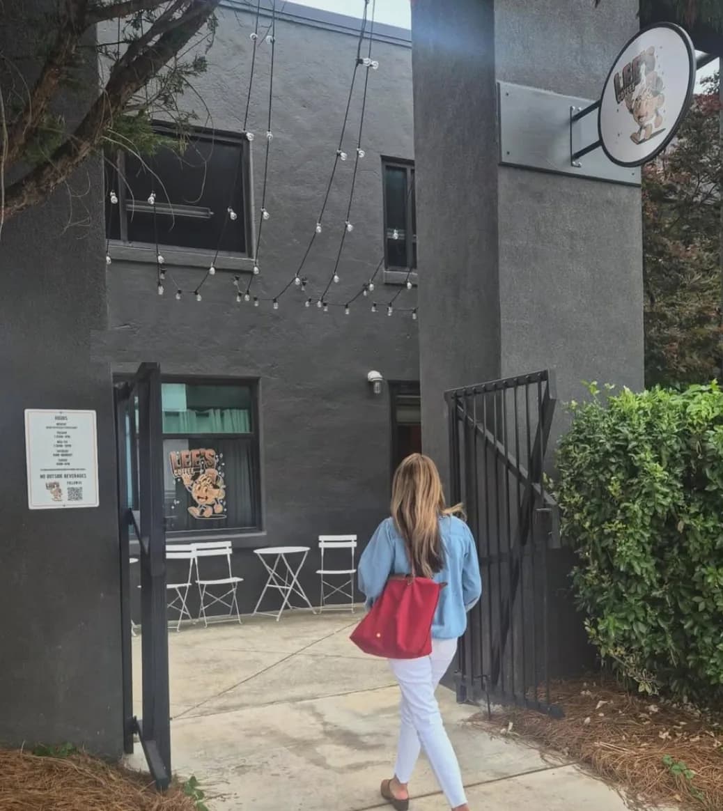 The entrance to Lee's Coffee inside WorkPlay, with string lights over the patio and a hanging sign