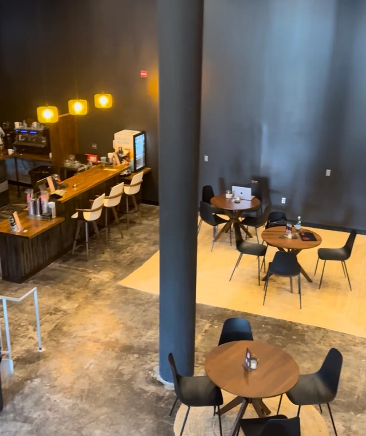 The bar and dining room at Lee's Coffee, with a laptop open at a table