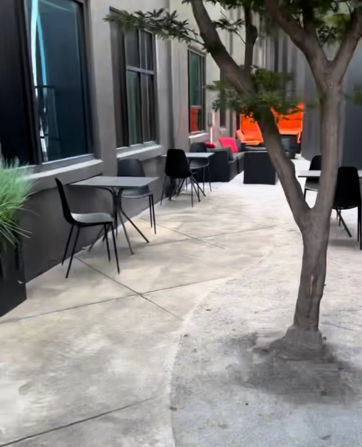 Black cafe tables and chairs on the patio outside Lee's Coffee